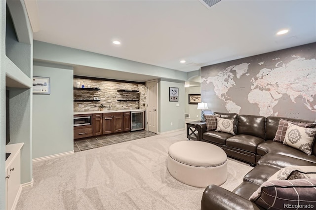 living area featuring wet bar, recessed lighting, wine cooler, light carpet, and an accent wall