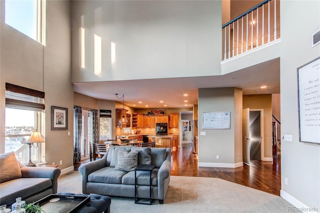 living room featuring a towering ceiling