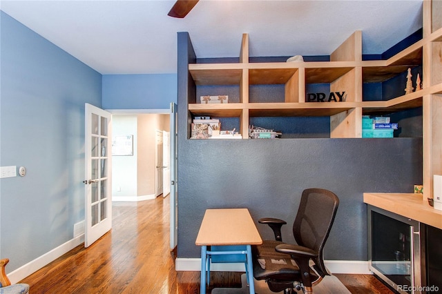 home office with hardwood / wood-style flooring and french doors