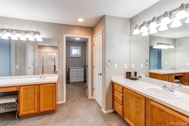 bathroom with vanity and a shower with shower door