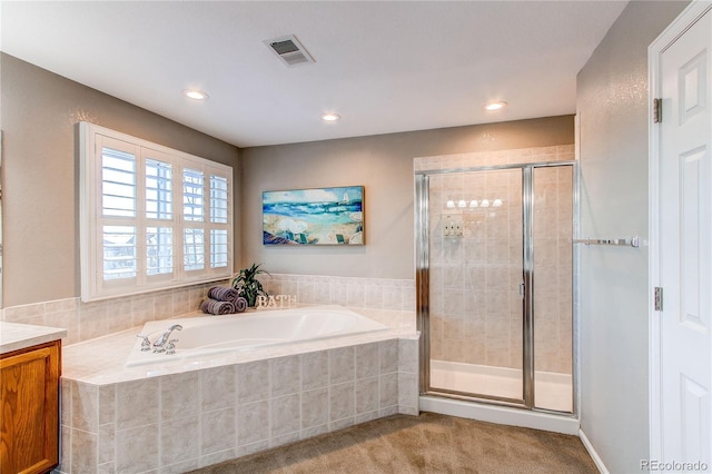 bathroom featuring independent shower and bath