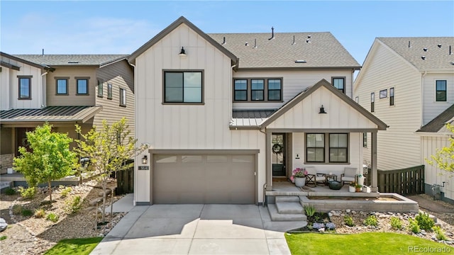 9140 Moondance Dr, Littleton, CO 80125 - view of front of home featuring board and batten siding, covered porch, a standing seam roof, and driveway