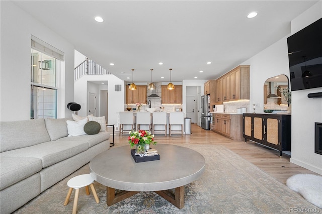9140 Moondance Dr, Littleton, CO 80125 - living area featuring light wood-style floors and recessed lighting