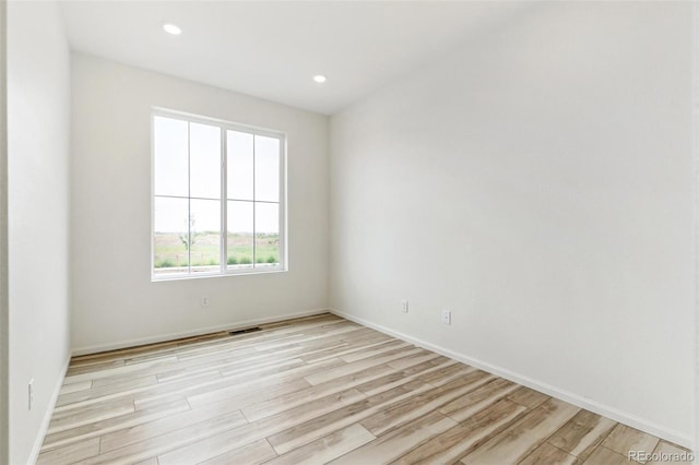 unfurnished room featuring light hardwood / wood-style floors