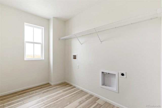 laundry area with electric dryer hookup, hookup for a washing machine, and light wood-type flooring