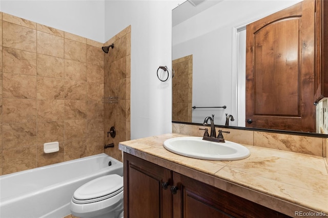 full bath featuring toilet, vanity, and bathing tub / shower combination