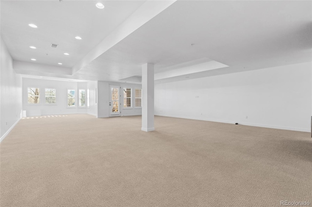 unfurnished living room with recessed lighting, light colored carpet, visible vents, and baseboards