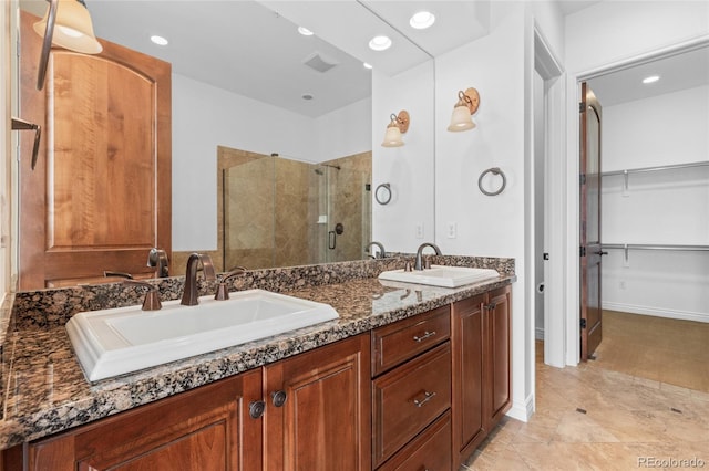 7882 Vallagio Ln, Englewood, CO 80112 - full bathroom with a stall shower, double vanity, a walk in closet, and recessed lighting