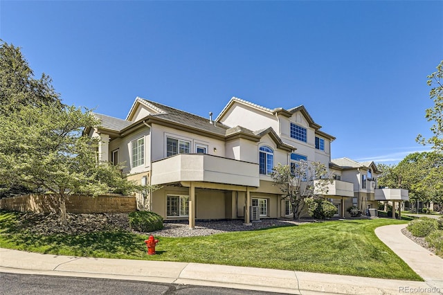 2761 W 106th Loop Unit C, Denver, CO 80234 - view of front of property with stucco siding and a balcony