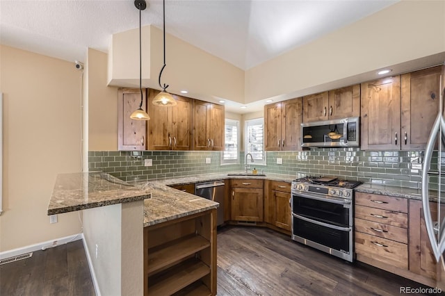 2761 W 106th Loop Unit C, Denver, CO 80234 - kitchen with stainless steel appliances, a peninsula, brown cabinetry, light stone counters, and dark wood-style flooring