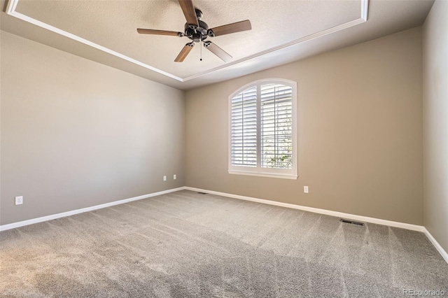 2761 W 106th Loop Unit C, Denver, CO 80234 - spare room with a ceiling fan, a tray ceiling, a textured ceiling, carpet, and baseboards