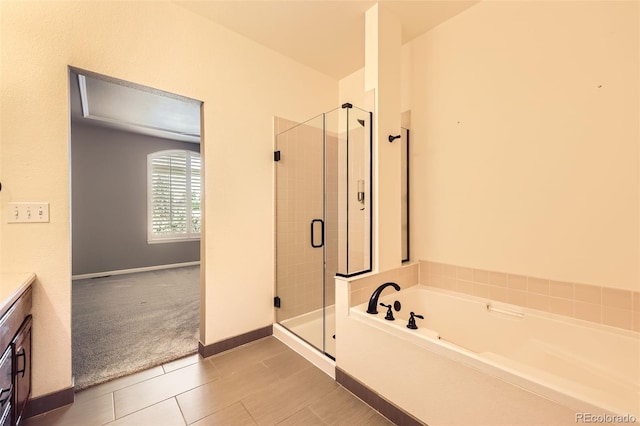 2761 W 106th Loop Unit C, Denver, CO 80234 - bathroom featuring a shower stall, a bath, vanity, tile patterned floors, and baseboards