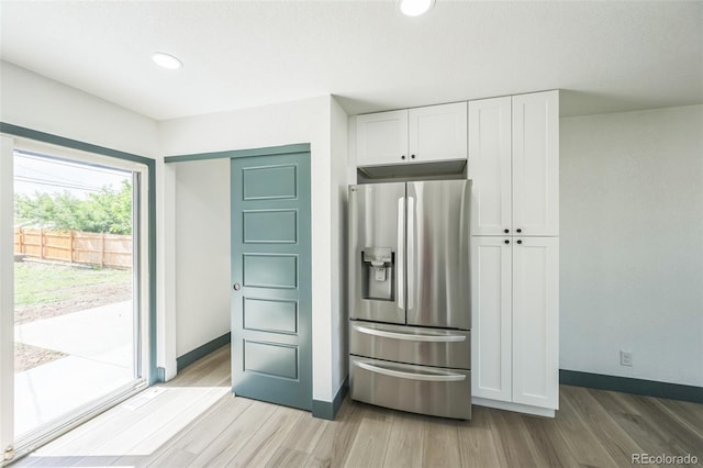 7810 Larkwood St, Commerce City, CO 80022 - kitchen with stainless steel refrigerator with ice dispenser, light wood-style flooring, white cabinets, and recessed lighting