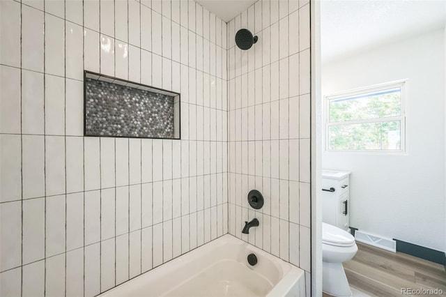 7810 Larkwood St, Commerce City, CO 80022 - bathroom with wood finished floors and bathing tub / shower combination