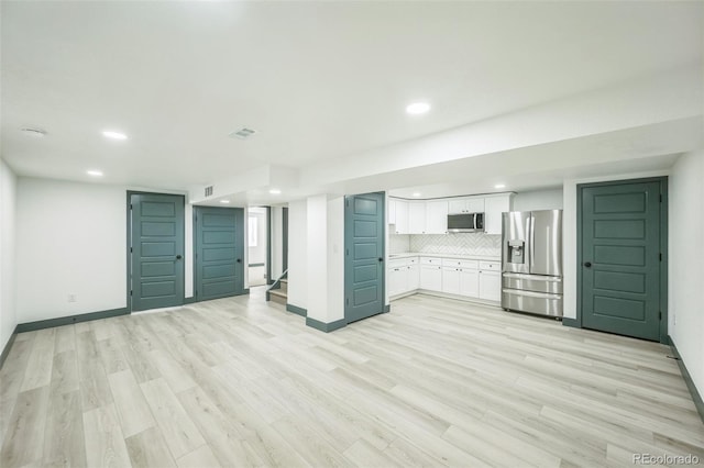 7810 Larkwood St, Commerce City, CO 80022 - unfurnished living room with recessed lighting, light wood finished floors, and stairway