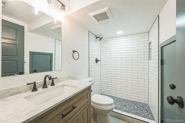 7810 Larkwood St, Commerce City, CO 80022 - bathroom featuring vanity, a stall shower, and a textured ceiling