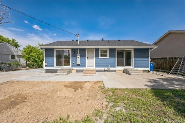 7810 Larkwood St, Commerce City, CO 80022 - rear view of property with entry steps, a patio area, and roof with shingles