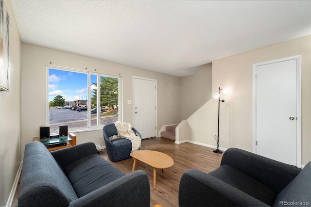 living room with hardwood / wood-style flooring and a textured ceiling