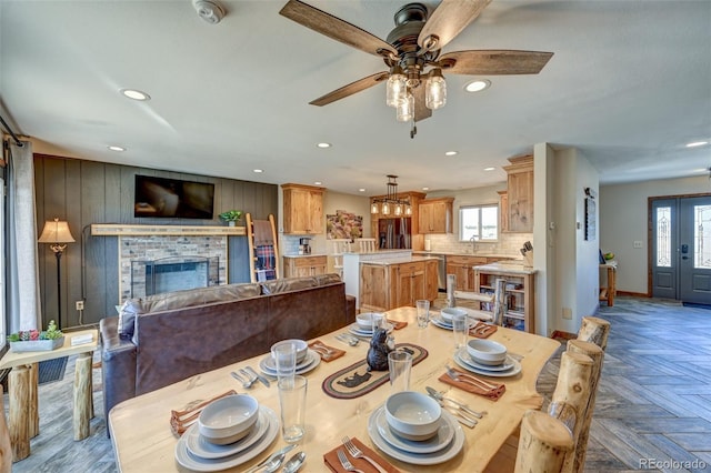 dining area with recessed lighting, a brick fireplace, plenty of natural light, and baseboards