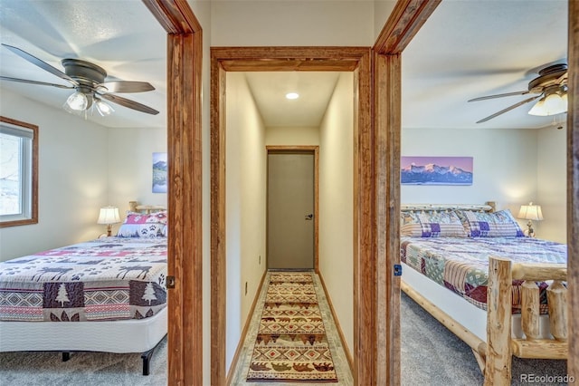 bedroom featuring carpet floors, a ceiling fan, and baseboards