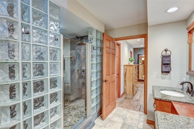 full bathroom featuring a stall shower, recessed lighting, and vanity