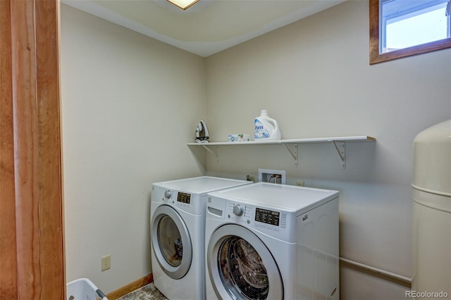 washroom featuring baseboards, laundry area, and washer and dryer