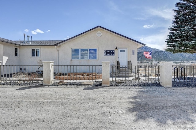 view of front of property featuring a fenced front yard and stucco siding