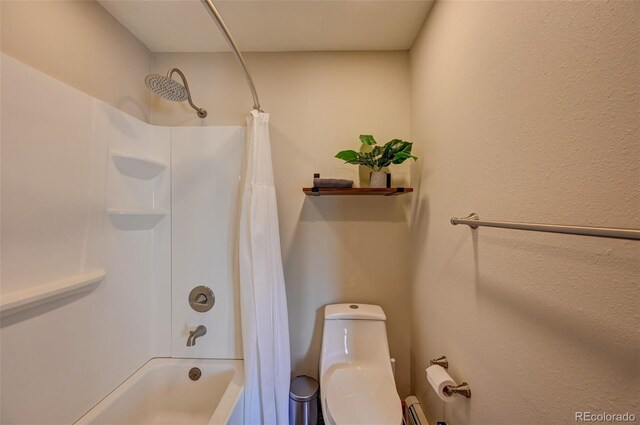 bathroom with shower / bath combo with shower curtain and toilet