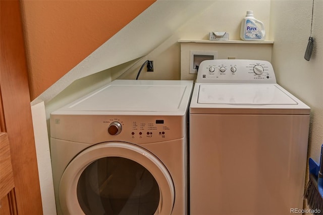 washroom featuring laundry area and separate washer and dryer