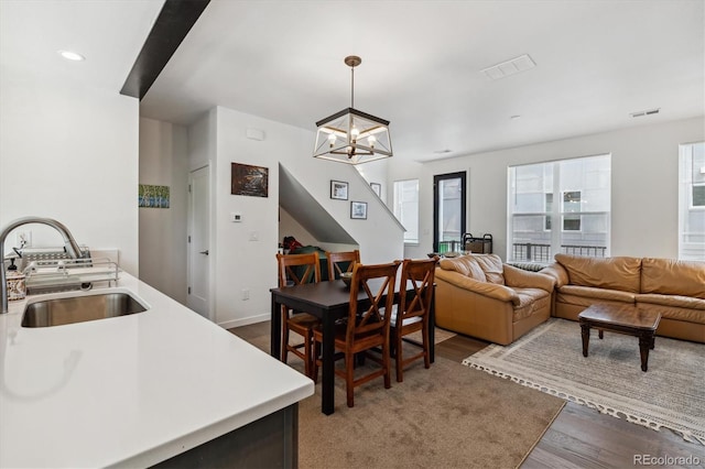 interior space featuring a chandelier, sink, wood-type flooring, and a wealth of natural light