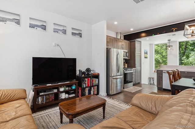 living room featuring sink and hardwood / wood-style floors