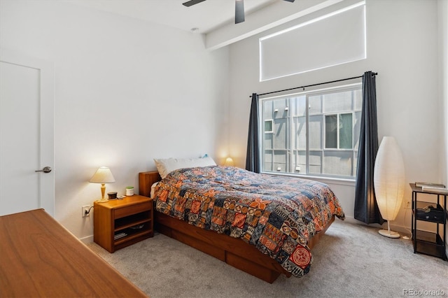 bedroom with ceiling fan and light colored carpet