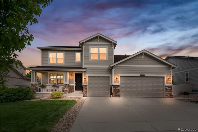 12032 Triple Crown Dr, Parker, CO 80134 - craftsman-style home with covered porch, concrete driveway, a garage, stone siding, and a lawn