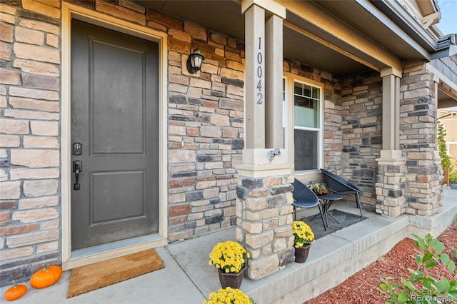 view of exterior entry featuring a porch