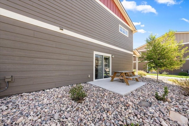 3674 Ronald Reagan Ave, Wellington, CO 80549 - rear view of property with board and batten siding and a patio area