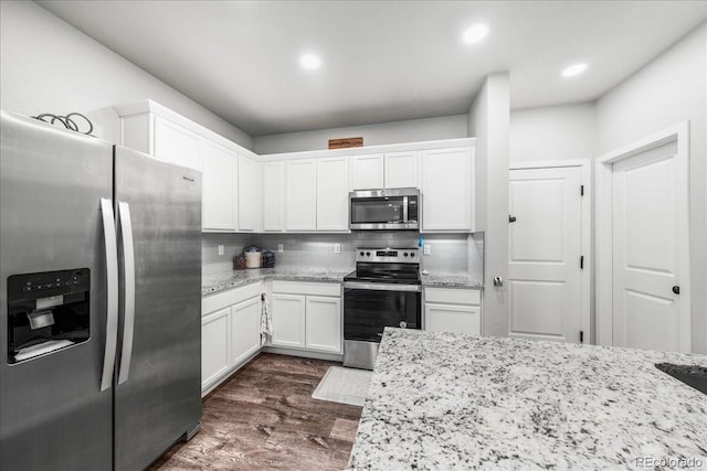 3674 Ronald Reagan Ave, Wellington, CO 80549 - kitchen featuring stainless steel appliances, white cabinetry, light stone countertops, and recessed lighting