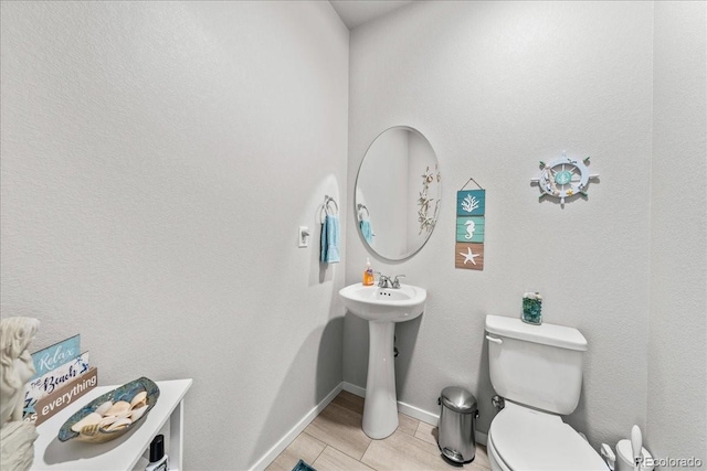 3674 Ronald Reagan Ave, Wellington, CO 80549 - bathroom with toilet, baseboards, and a sink