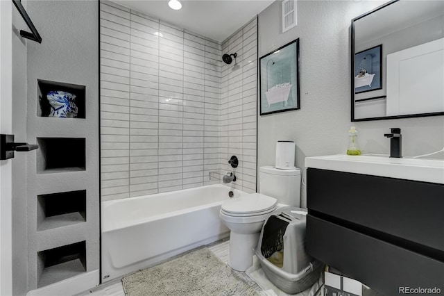 full bathroom with tiled shower / bath, vanity, toilet, and hardwood / wood-style floors