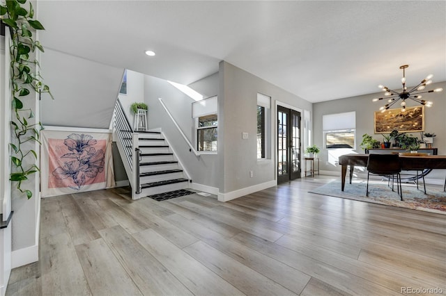 foyer with a chandelier and light hardwood / wood-style floors