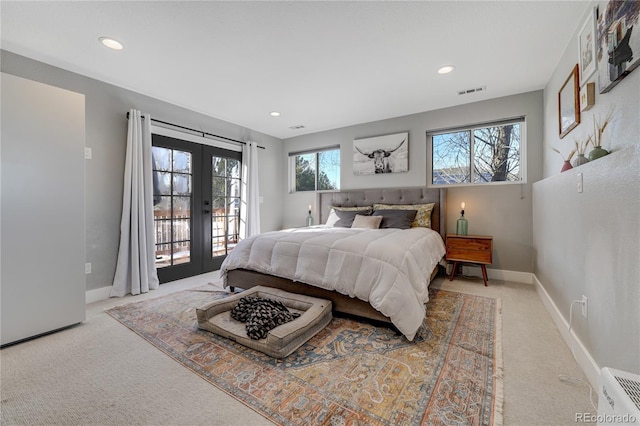 carpeted bedroom with french doors and access to exterior