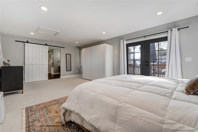 bedroom featuring light carpet, access to exterior, a barn door, and french doors