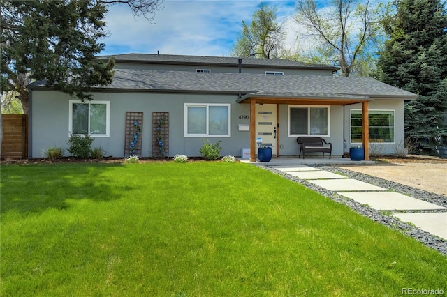 rear view of house featuring covered porch, stucco siding, and roof with shingles