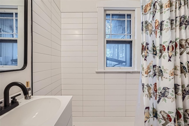 bathroom featuring walk in shower and sink