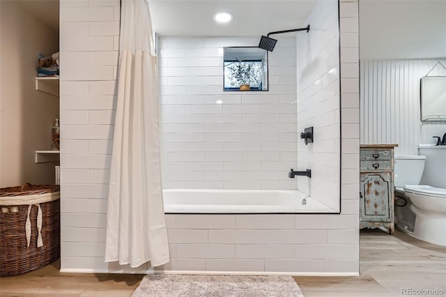 bathroom with toilet, hardwood / wood-style flooring, and shower / bath combo with shower curtain