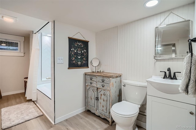 full bathroom with toilet, shower / bath combo, vanity, and hardwood / wood-style flooring