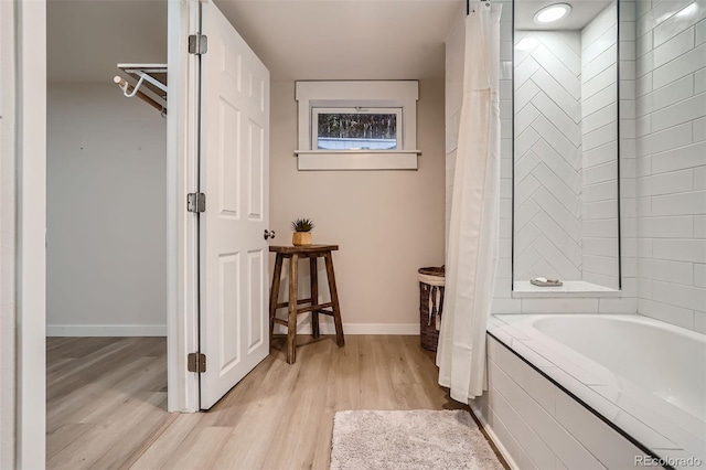 bathroom with shower with separate bathtub and hardwood / wood-style flooring