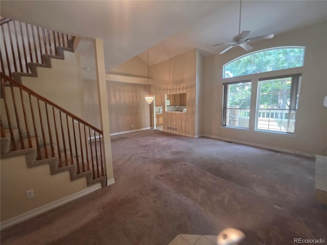 8911 Tappy Toorie Pl, Highlands Ranch, CO 80129 - unfurnished living room featuring carpet, stairway, a ceiling fan, and high vaulted ceiling