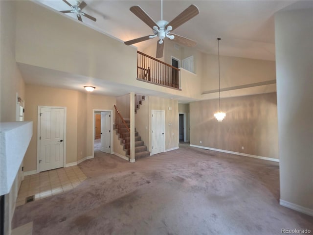 8911 Tappy Toorie Pl, Highlands Ranch, CO 80129 - unfurnished living room featuring high vaulted ceiling, ceiling fan, carpet floors, and stairs