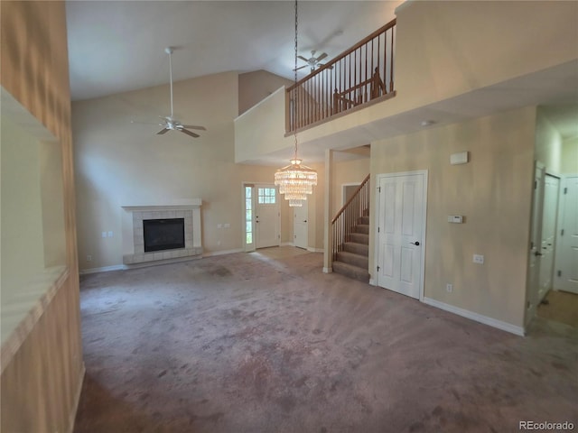 8911 Tappy Toorie Pl, Highlands Ranch, CO 80129 - unfurnished living room with ceiling fan, carpet flooring, a fireplace, high vaulted ceiling, and a chandelier