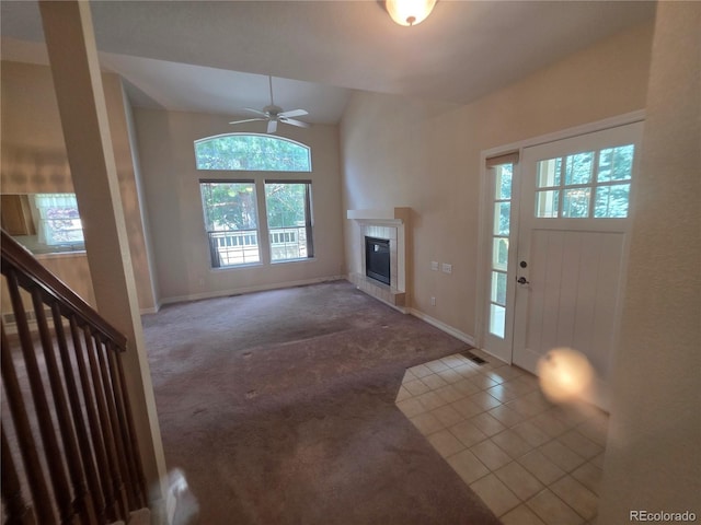 8911 Tappy Toorie Pl, Highlands Ranch, CO 80129 - carpeted foyer featuring plenty of natural light, a fireplace, a ceiling fan, tile patterned flooring, and lofted ceiling